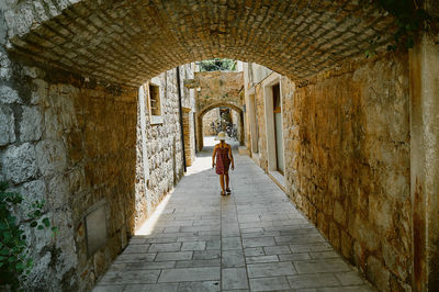 Full length rear view of man in historic building