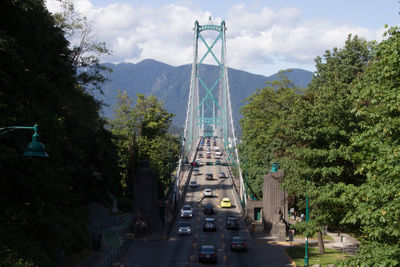 Cars on bridge against sky
