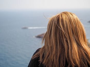 Rear view of woman against sea