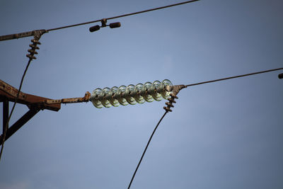 Low angle view of light bulbs against sky