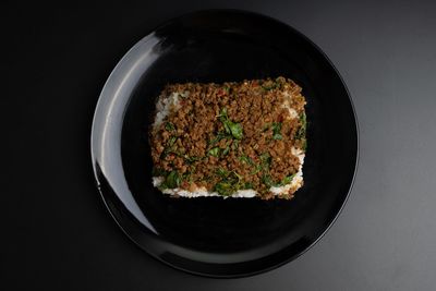 High angle view of food in bowl on table against black background