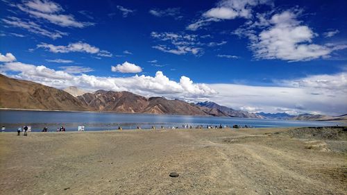 Scenic view of beach against blue sky
