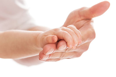 Cropped hand of person gesturing against white background