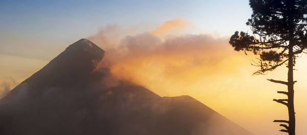 Scenic view of silhouette mountains against sky at sunset