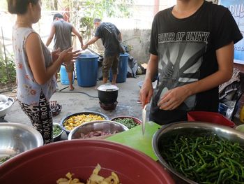 People standing by food