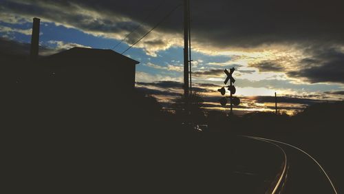 Silhouette of car against sky during sunset