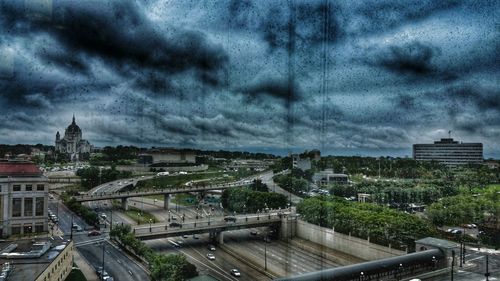 Cityscape against cloudy sky