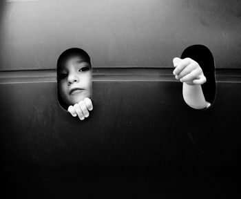 Close-up of girl looking through hole