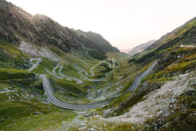 Scenic view of winding mountain road against sky