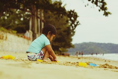 Girl playing on sand at beach