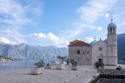 Church by building against sky