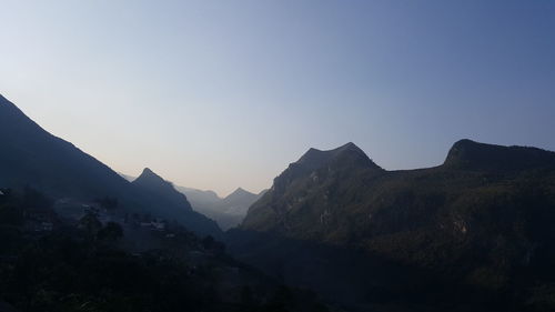 Scenic view of silhouette mountains against clear sky