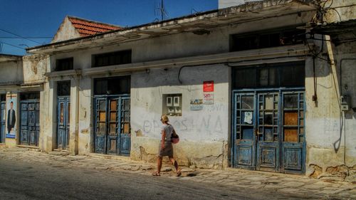 Full length of woman standing by railing