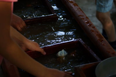 High angle view of workers washing seafood in water