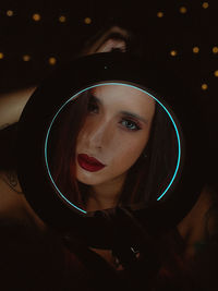 Close-up portrait of young woman wearing hat