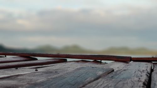 Surface level of wooden pier against sky
