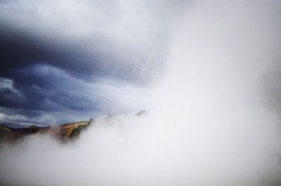 Scenic view of waterfall against sky