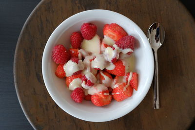 High angle view of strawberries in bowl on table