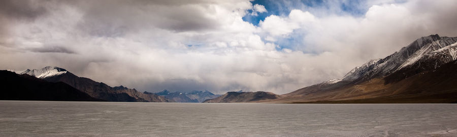 Scenic view of mountains against cloudy sky