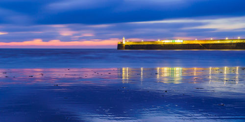 Scenic view of sea against sky at sunset