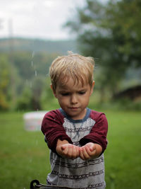 Portrait of cute girl playing with toy on field