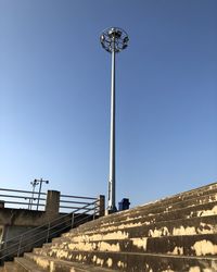 Low angle view of communications tower against clear blue sky