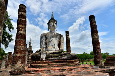 Statue of temple against cloudy sky