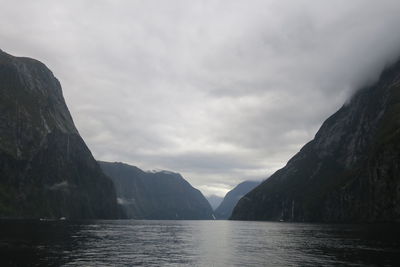 Scenic view of sea and mountains against sky