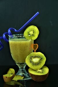 Close-up of fruits in glass against black background