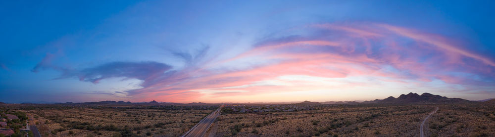 Panoramic view of field against sky during sunset