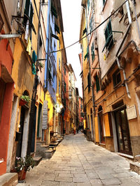 Low angle view of narrow alley amidst buildings in city