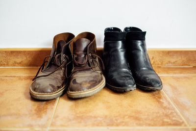 Close-up of shoes on hardwood floor against white background