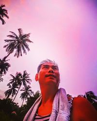 Low angle view of woman looking away against sky