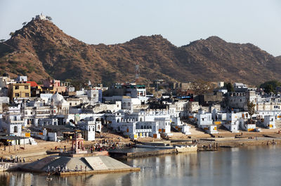 White buildings amidst lake and mountains