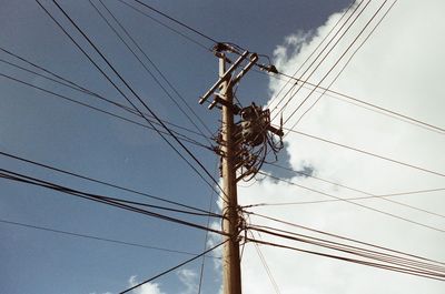 Low angle view of electricity pylon against sky