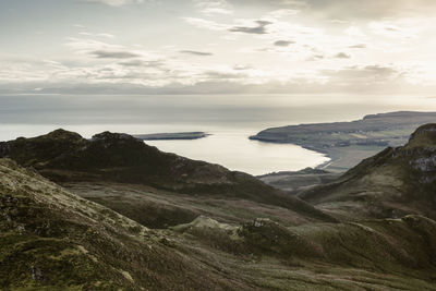 Scenic view of sea and mountains against sky