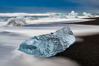 Blue ice on the black sand beach