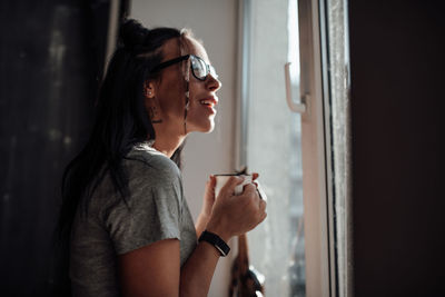 Side view of young woman looking away