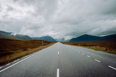 Empty road along countryside landscape