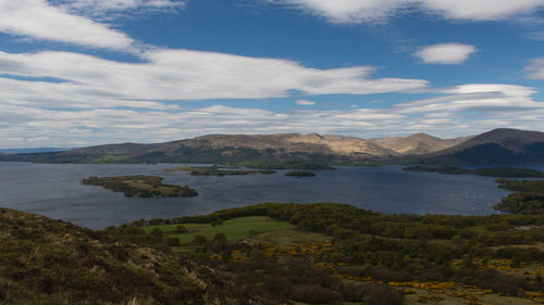 Scenic view of lake against cloudy sky