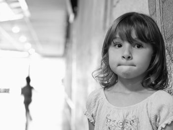 Close-up of girl standing by wall