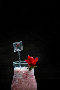 Close-up of drink in glass against black background