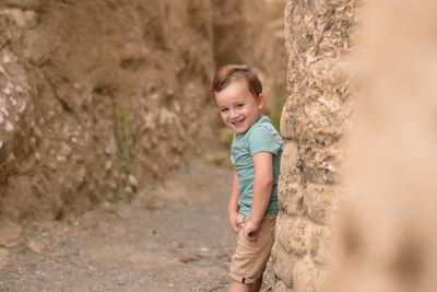 Portrait of boy standing on rock