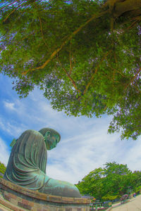 Low angle view of statue against cloudy sky