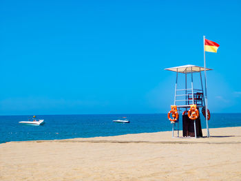 Scenic view of sea against clear blue sky