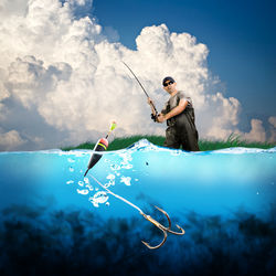Man with umbrella on sea against sky