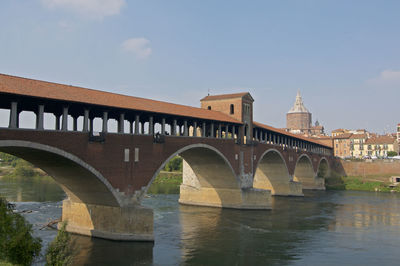 View of the ponte coperto or ponte vecchio bridge with the pavia cathedral in the background