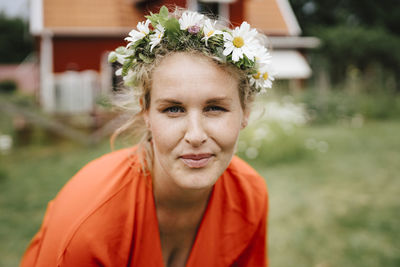 Portrait of smiling woman standing against plants