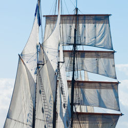 Low angle view of sailboat on sea against sky