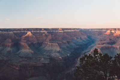 Scenic view of dramatic landscape against clear sky during sunset